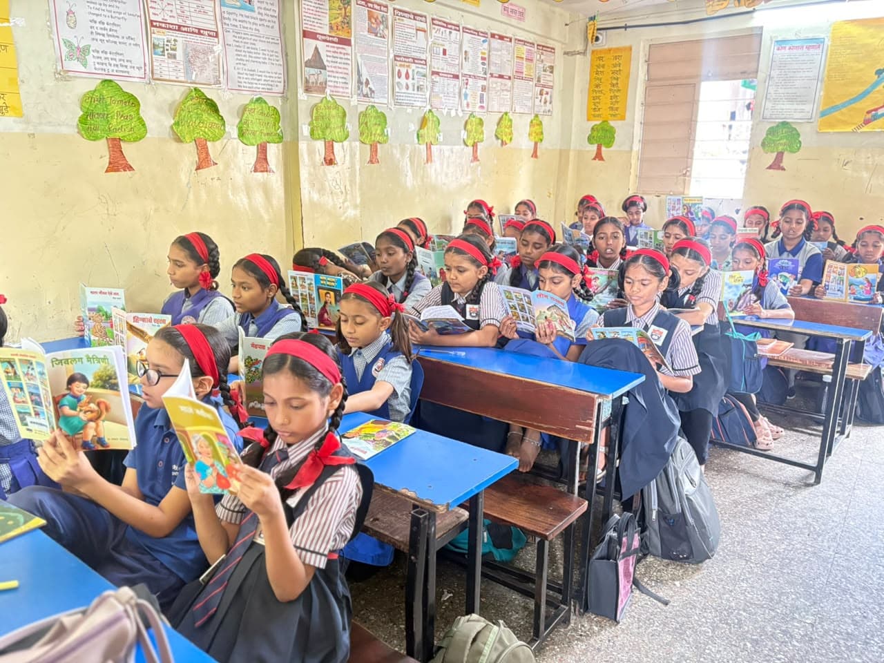 Schoolgirls reading books in class